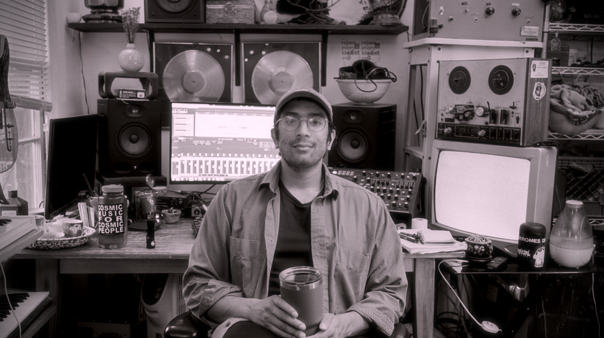 Terence sitting in front of his mixing setup with a mug of tea